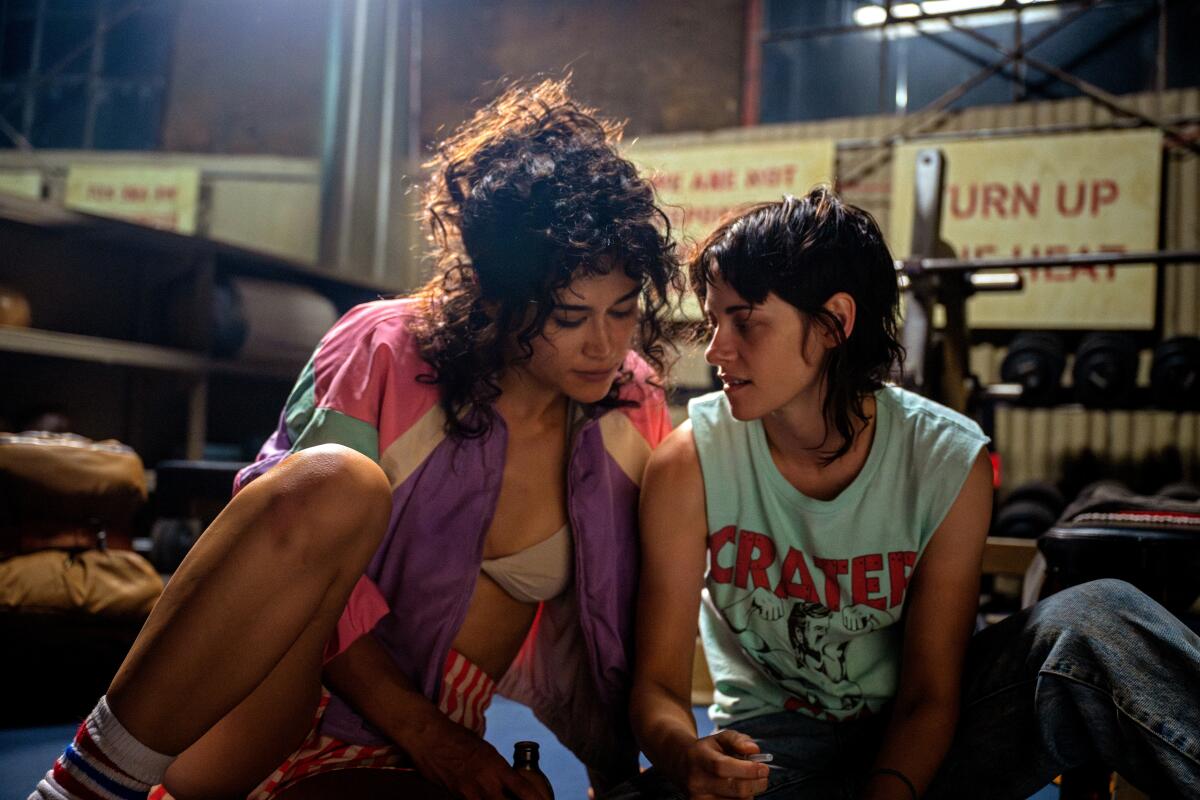 Two women make plans in a gym.