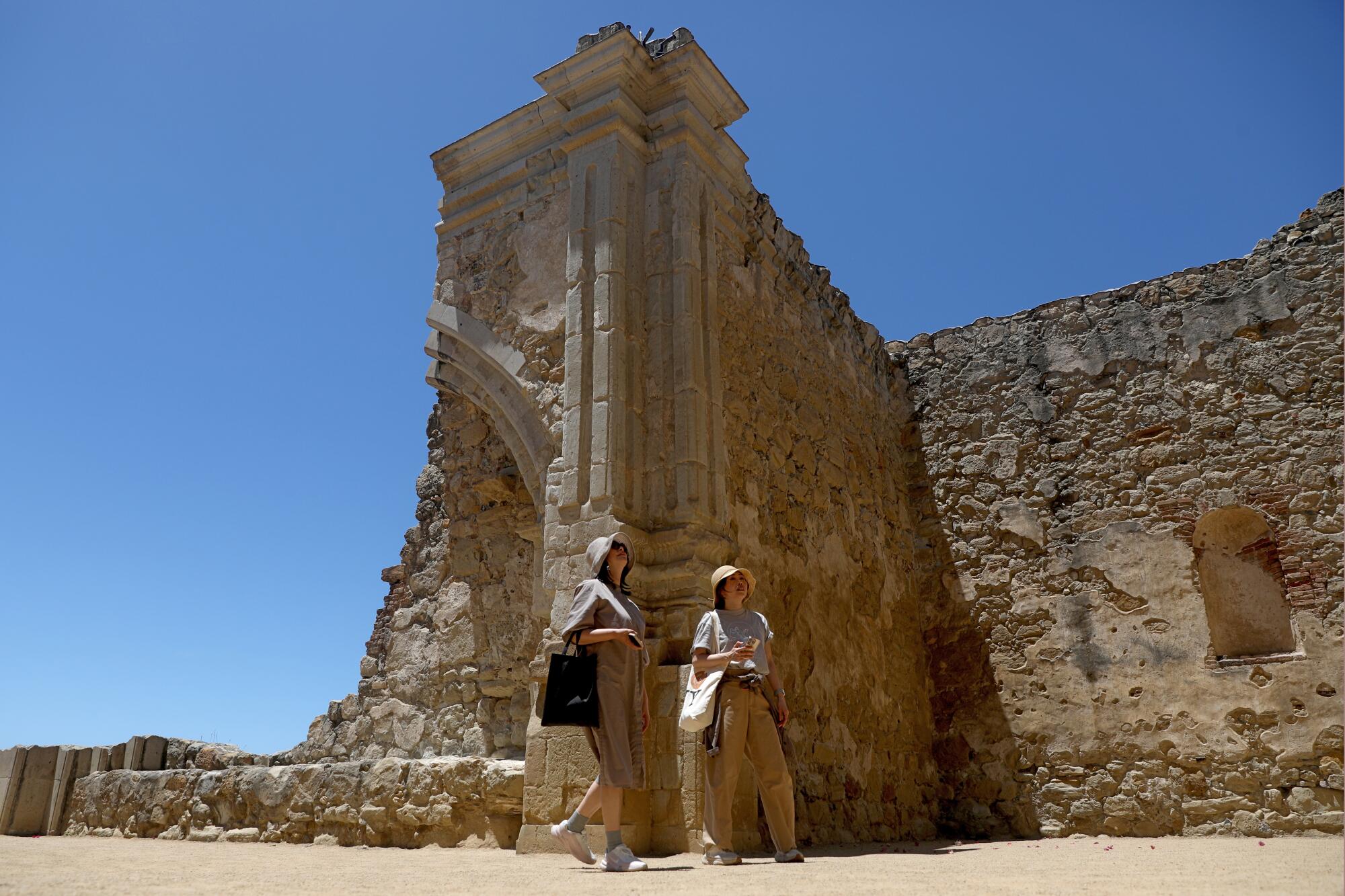 Guests walk among the ruins of the Great Stone Church.