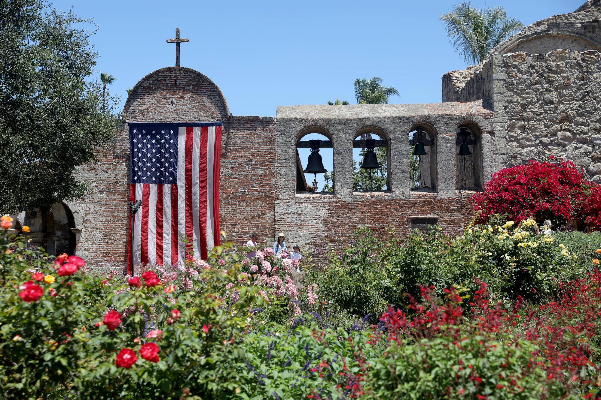 An American flag hangs on the Bell Wall at Mission San Juan Capistrano. 