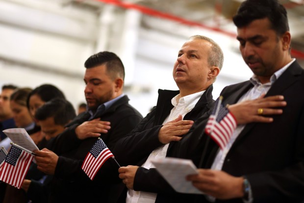 New citizens participate in the Pledge of Allegiance during a naturalization ceremony aboard the USS Hornet Sea, Air & Space Museum on Wednesday, July 1, 2026, in Alameda, Calif. A total of 76 community members from 28 different countries became new American citizens during the ceremony. (Aric Crabb/Bay Area News Group)