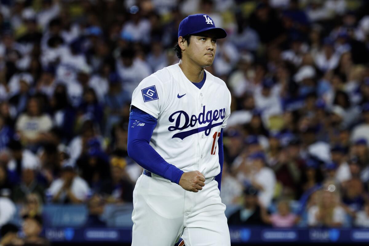 Dodgers pitcher Shohei Ohtani pumps his fist after getting San Diego's Manny Machado to ground out.