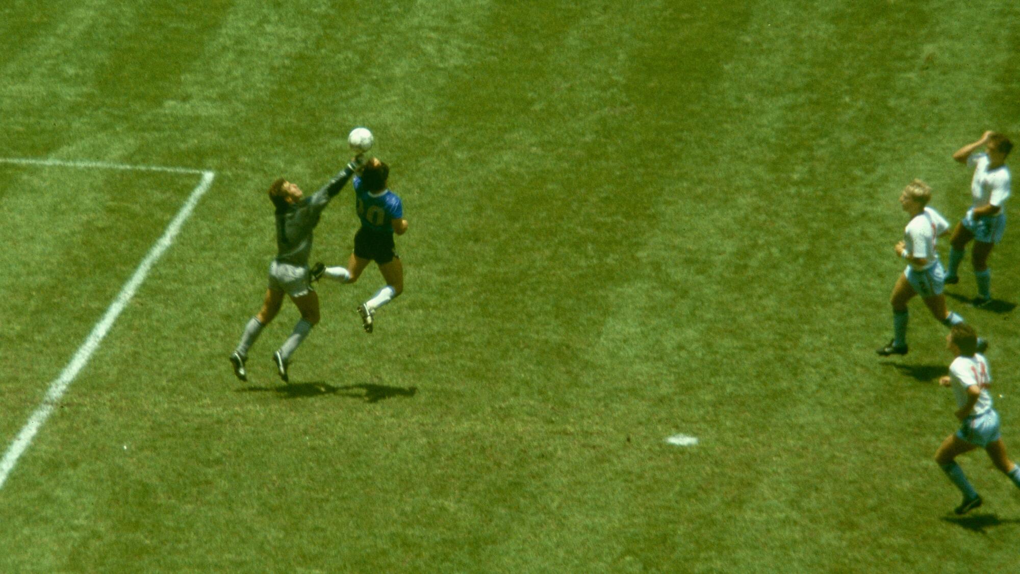 Argentina's Diego Maradona punches the ball past England goalkeeper Peter Shilton to score his "Hand of God" goal.