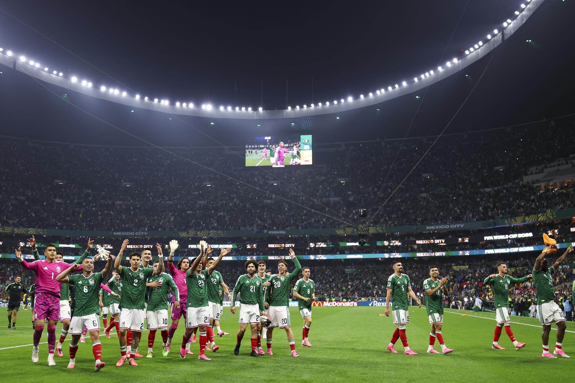 Mexico players celebrate after the team's World Cup win over Ecuador at Azteca Stadium on Tuesday.