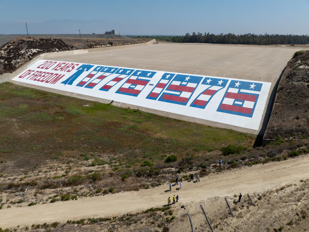 An aerial view of community coordinators visiting the Prado Dam Bicentennial Mural at Prado Dam.