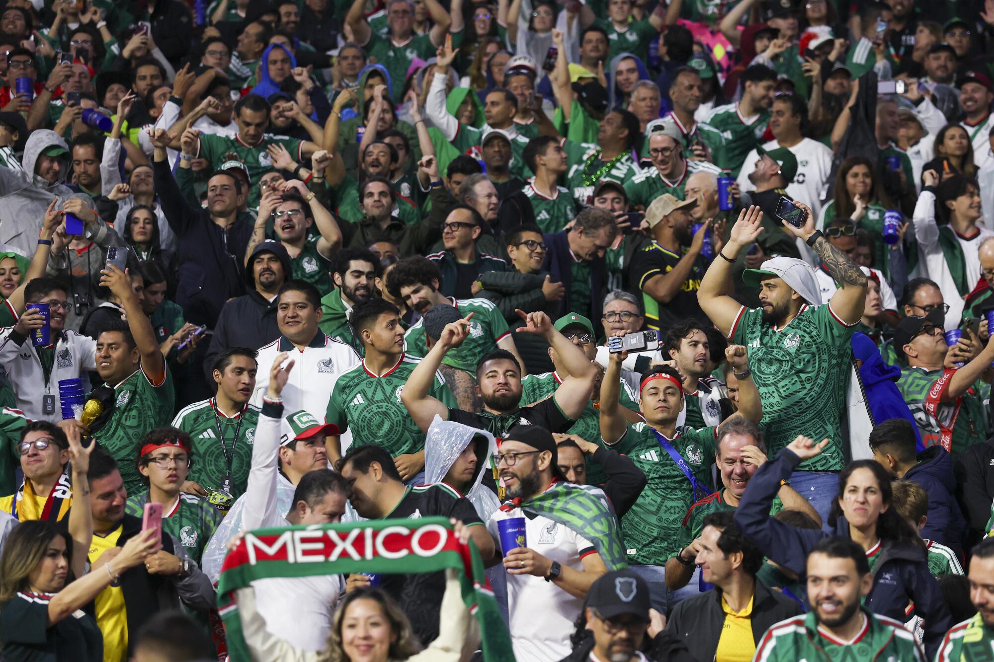 Mexico fans celebrate after the team's World Cup win over Ecuador at Azteca Stadium on Tuesday in Mexico City.