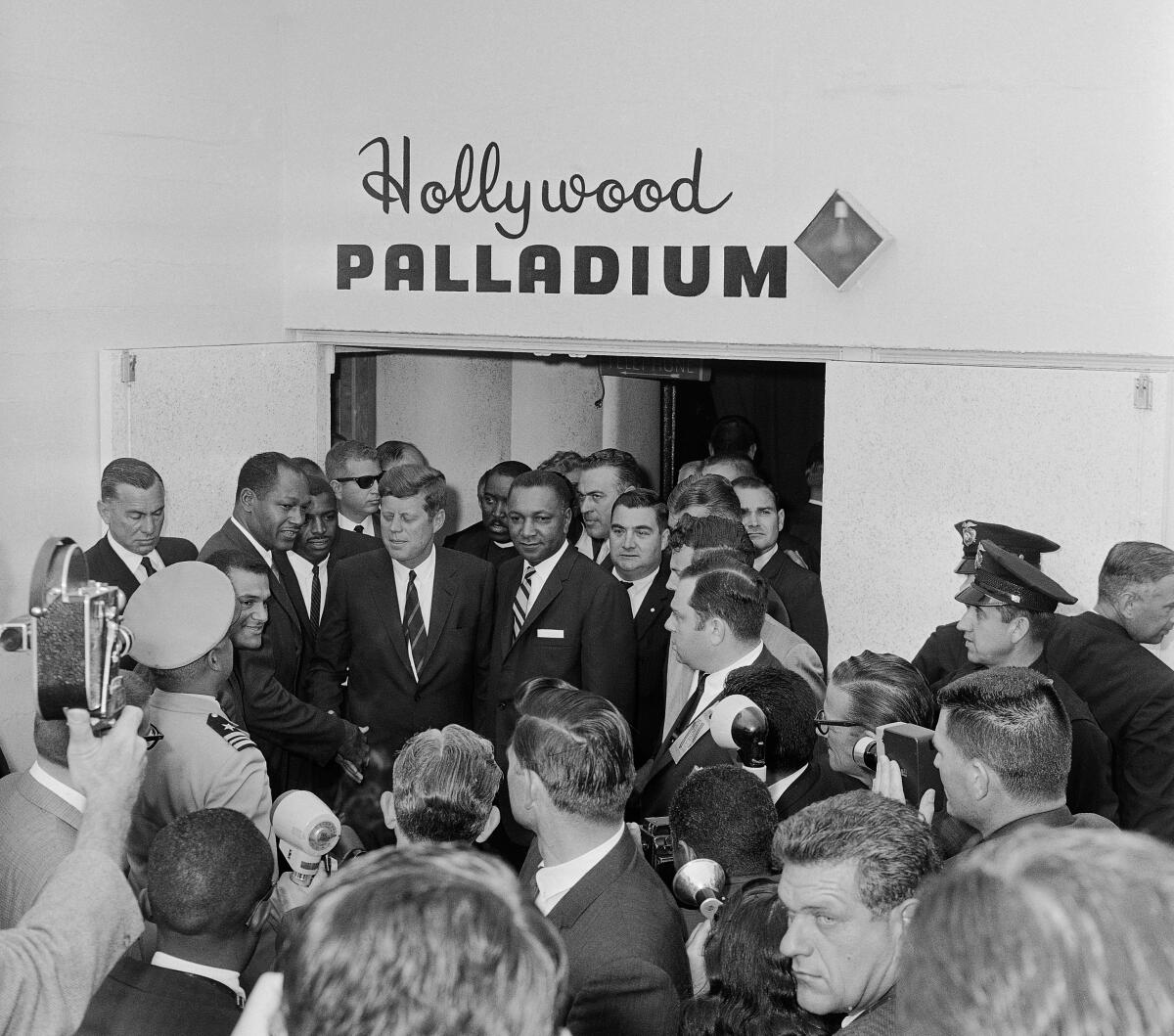 President John Kennedy is greeted by a delegation of Los Angeles black leaders including Billy G. Mills. (AP Photo)