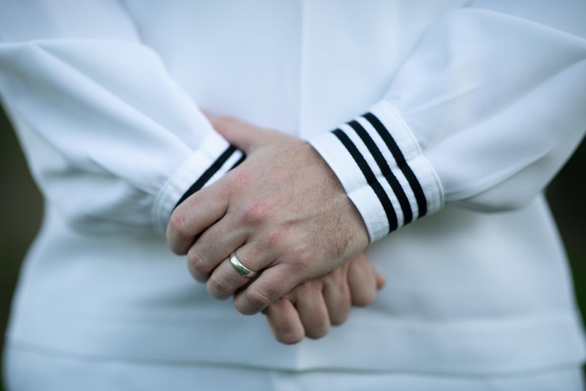 A close-up of a wedding ring on a left ring finger