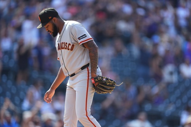 San Francisco Giants relief pitcher Dylan Smith reacts after giving up a three-run home run to Colorado Rockies' Kyle Karros in the eighth inning of a baseball game Sunday, July 5, 2026, in Denver. (AP Photo/David Zalubowski)