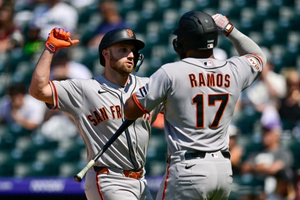 Casey Schmitt #10 of the San Francisco Giants celebrates with Heliot Ramos #17 after his fifth inning solo home run against the Colorado Rockies at Coors Field on July 5, 2026 in Denver, Colorado. (Photo by Dustin Bradford/Getty Images)