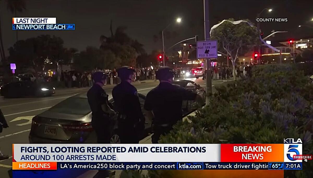 Police Saturday watch from a distance as multiple agencies attempt to control crowds drawn to Newport Beach for July 4.