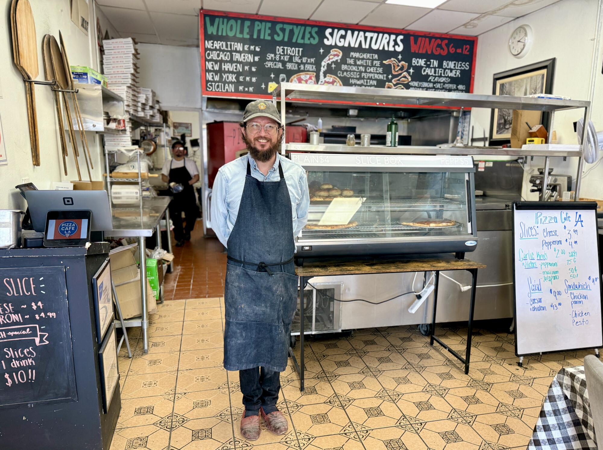 Diego Garcia stands in his pizza place.