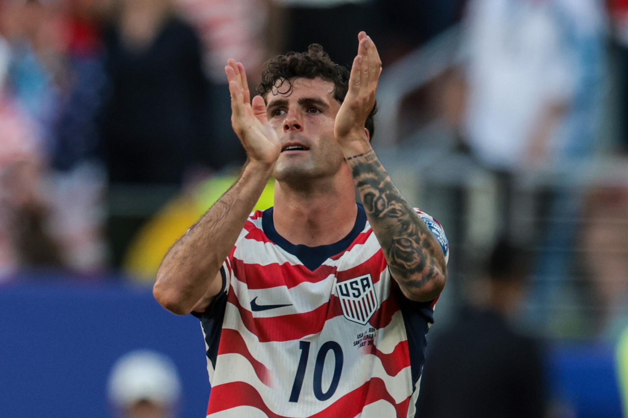 U.S. forward Christian Pulisic recognizes the fans after a win over Bosnia and Herzegovina.
