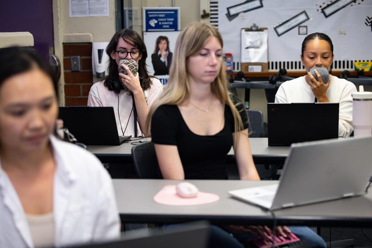 Students sit in a classroom setting.