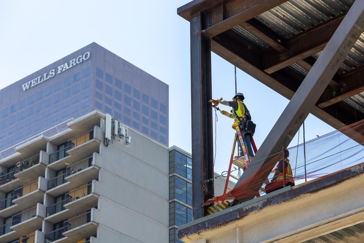 A construction worker works on a building in downtown Los Angeles