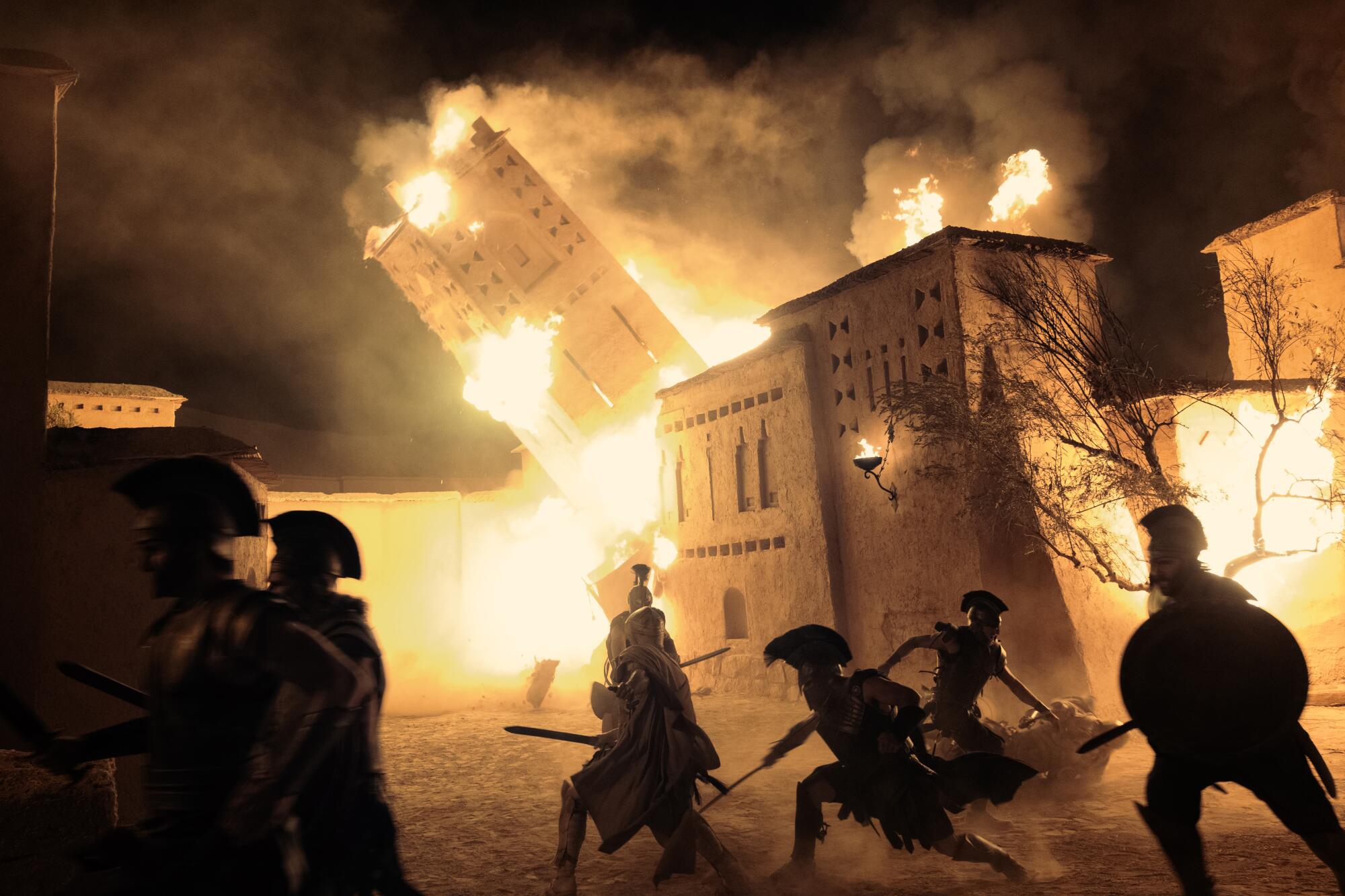 Soldiers attack a burning city.