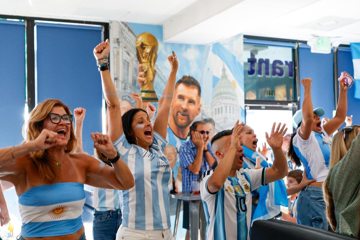 Fans cheer after Lionel Messi scores a goal against Algeria during a Argentina World Cup watch party at Mercado Buenos Aires 