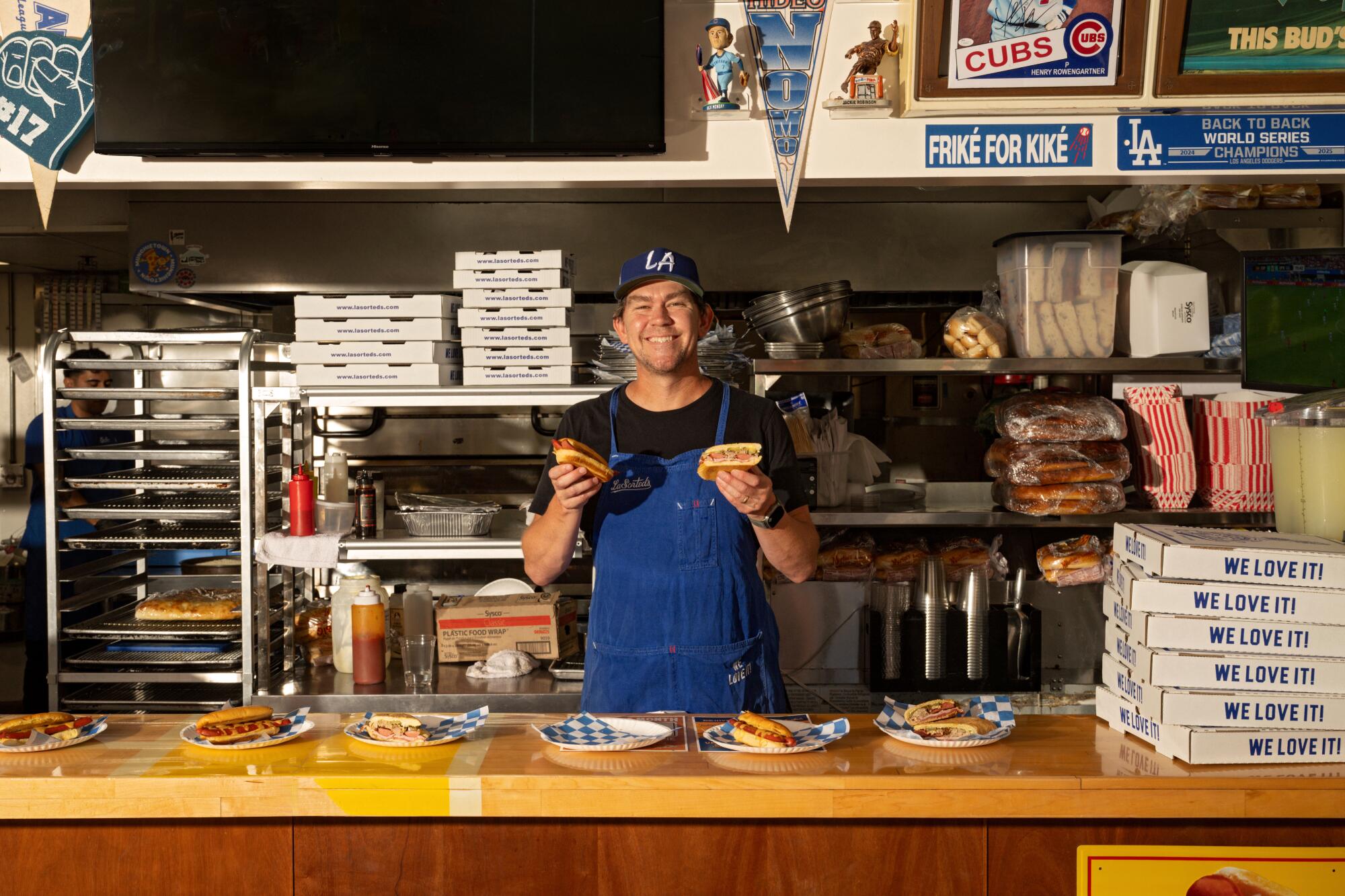 Owner Tommy Brockert at LaSorted's in the kitchen holding his hot dogs in Los Angeles.
