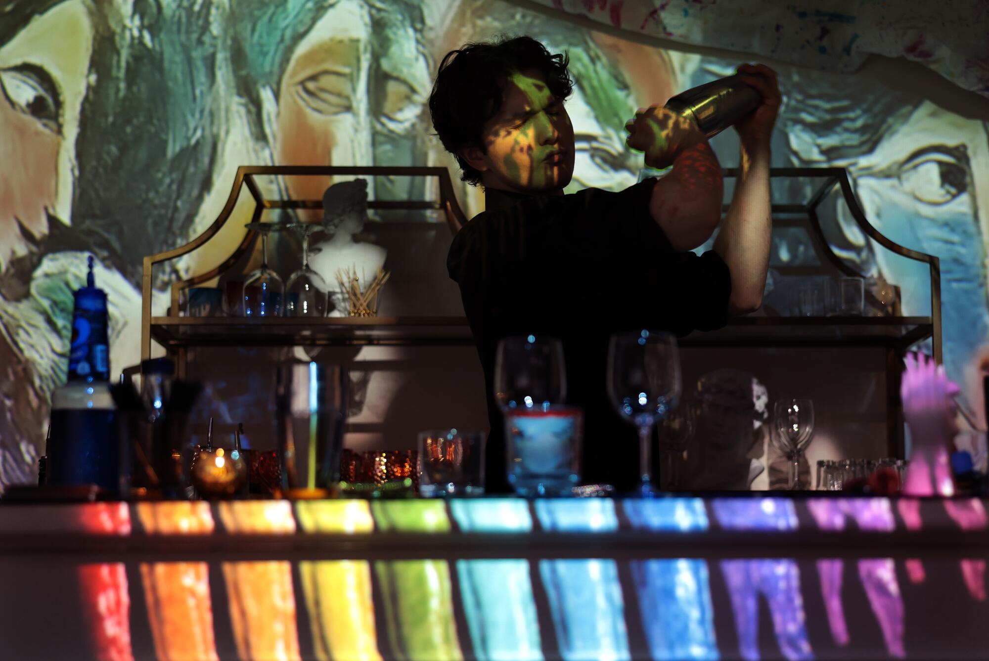 Bartender Luca Famulari shakes a cocktail at the immersive dining event.