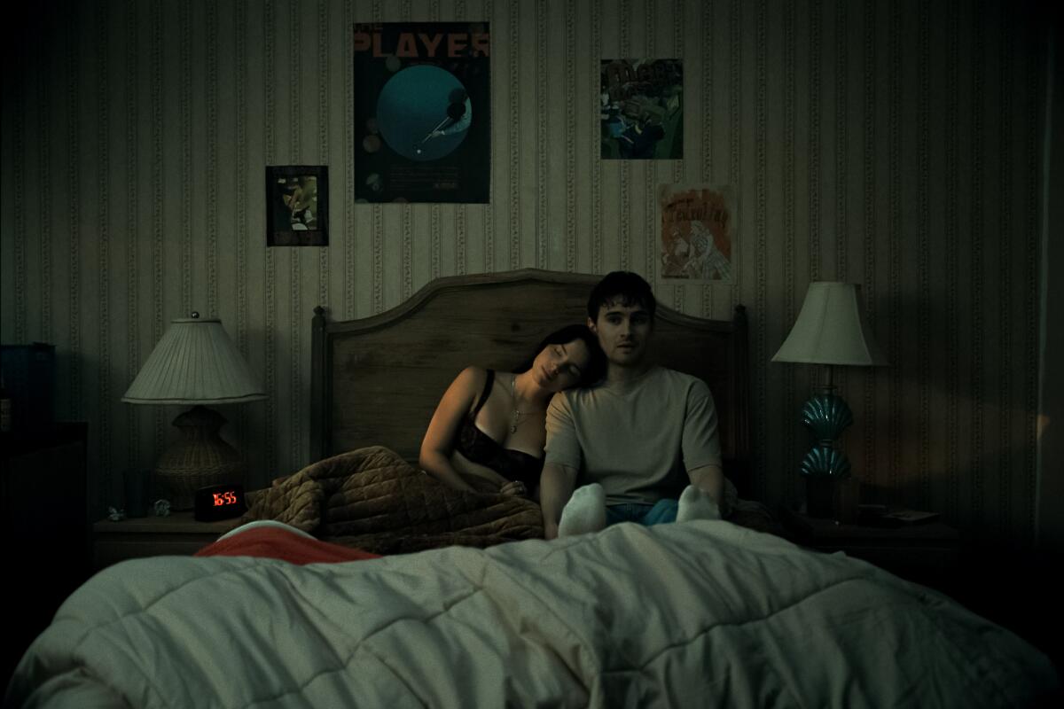 Two people awake in a bed together