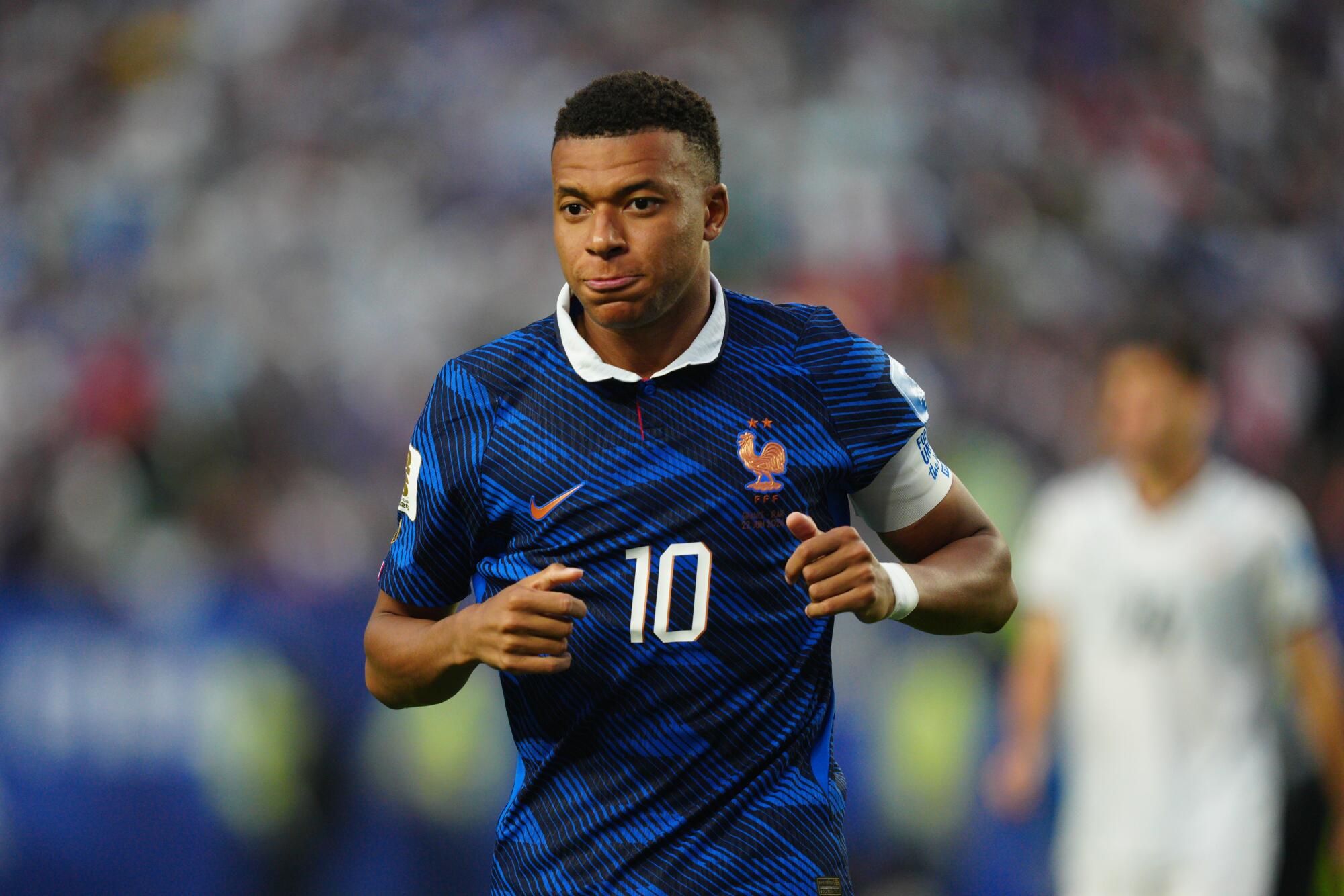 France's Kylian Mbappé jogs on the field during a win over Iraq in the World Cup on June 22.