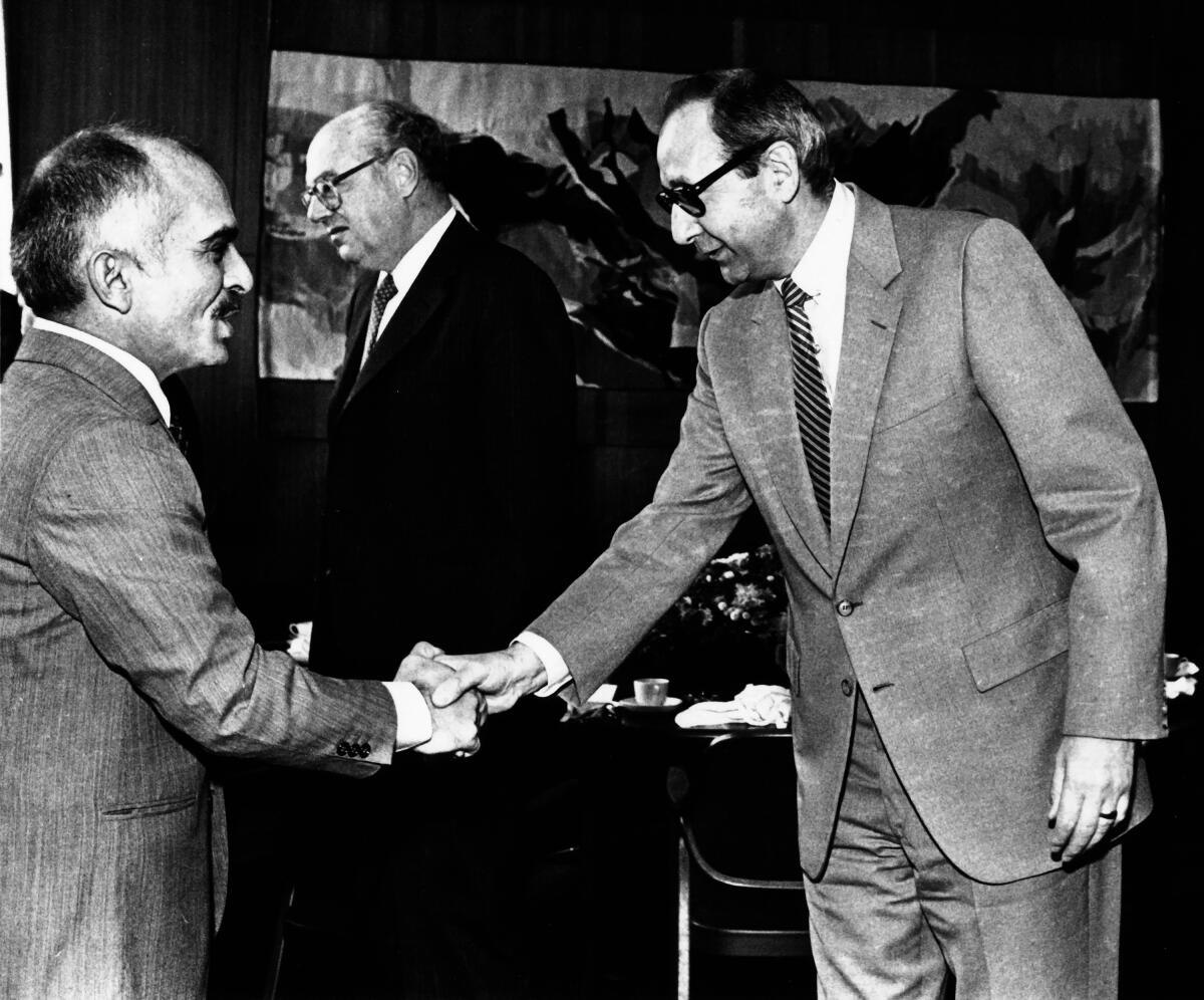 Los Angeles Managing Editor George Cotliar, right, greets King Hussein of Jordan at a reception at the Times, circa 1980s. 