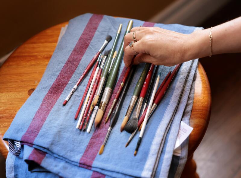 TORRANCE, CA - June 24, 2026: Esme Saleh paints candles at her home in Torrance on Wednesday, June 24, 2026. (Christina House / Los Angeles Times)