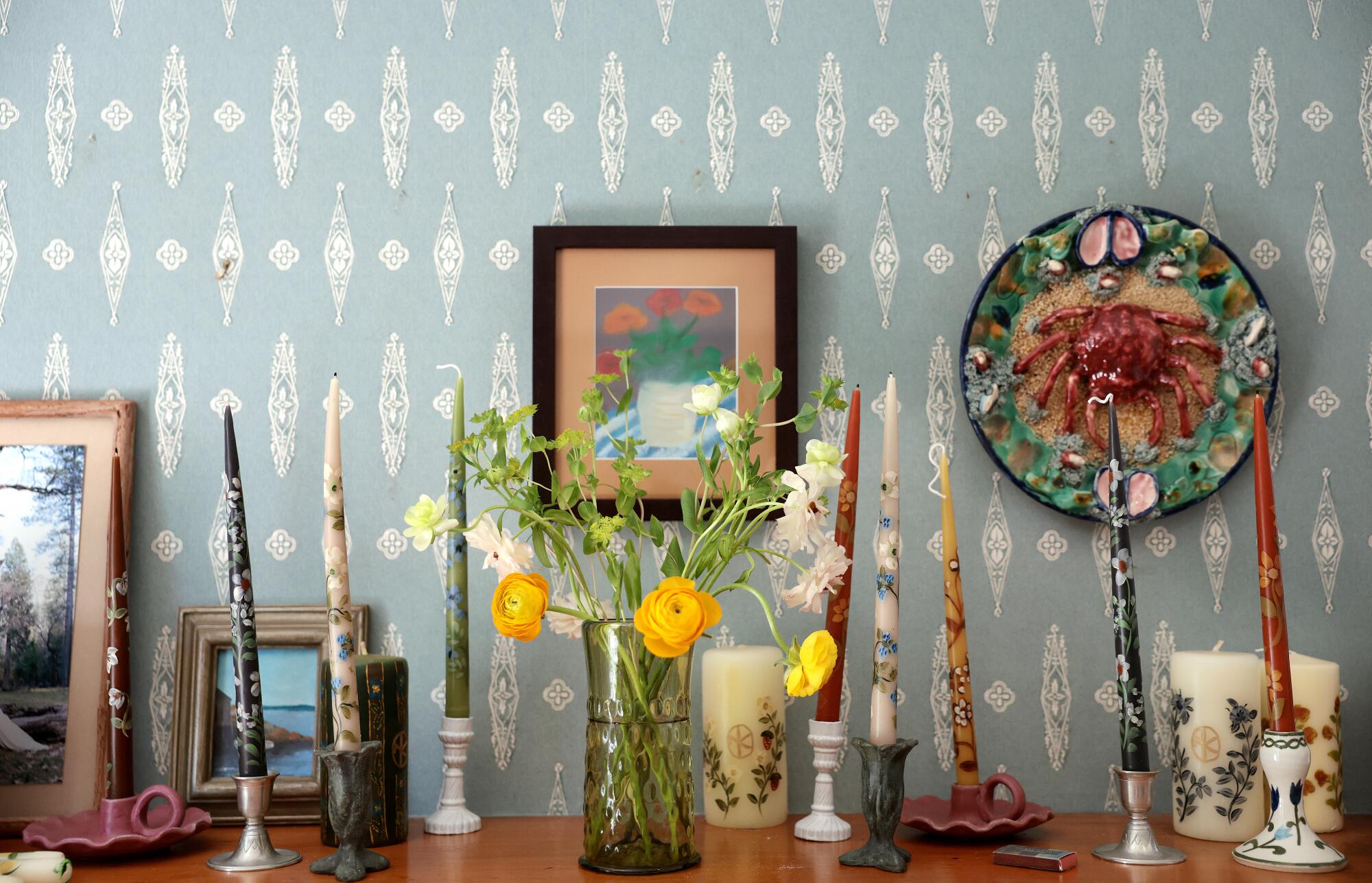 Candles and flowers decorate the mantle at Esme Saleh's home.