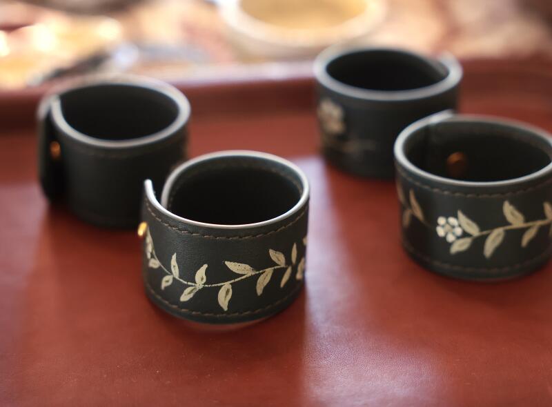 Leather napkin rings Saleh has painted for Nathan Turner.