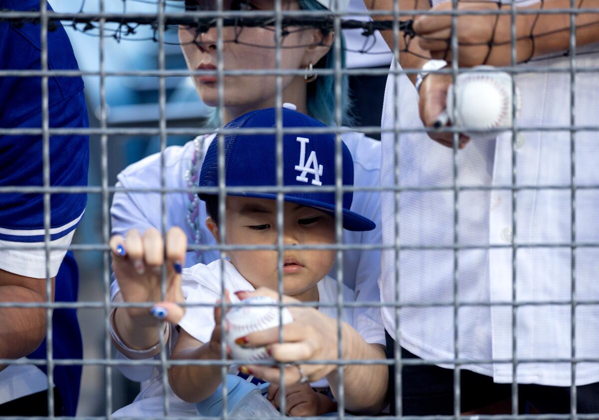 Fans wait for the start of a game between the Dodgers and the Rockies at UNIQLO Field at Dodger Stadium