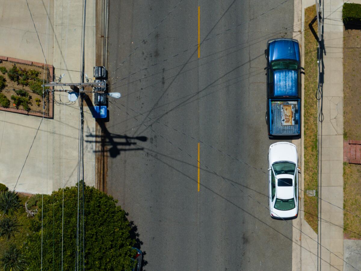 Telephone poles carrying utility lines hang over Canyon Drive in Los Angeles on Thursday.