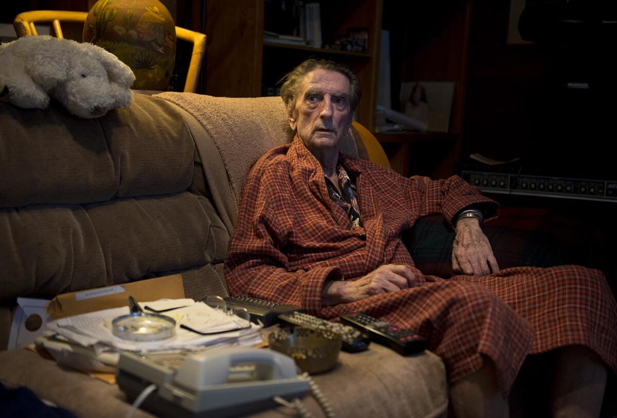 A man sits on a couch.