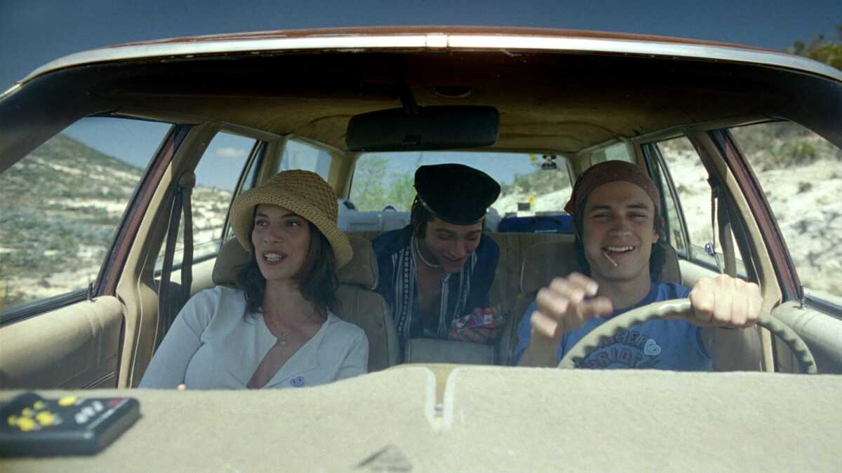 Three people drive in a car.