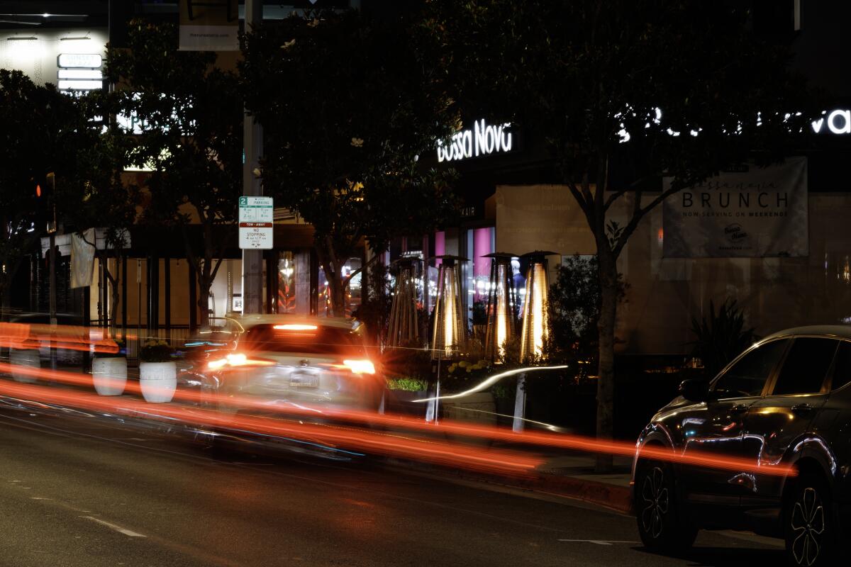 Vehicles stream by Bossa Nova, a Brazilian restaurant off Sunset Boulevard.