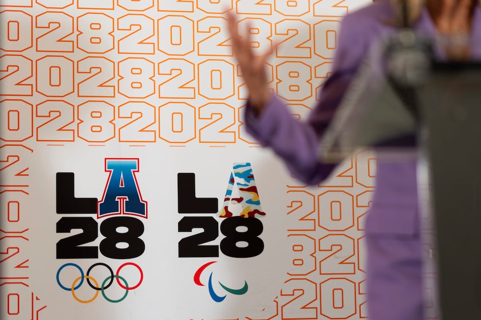 FILE - LA28 logos decorate a backdrop as First lady Jill Biden speaks at a reception at the...