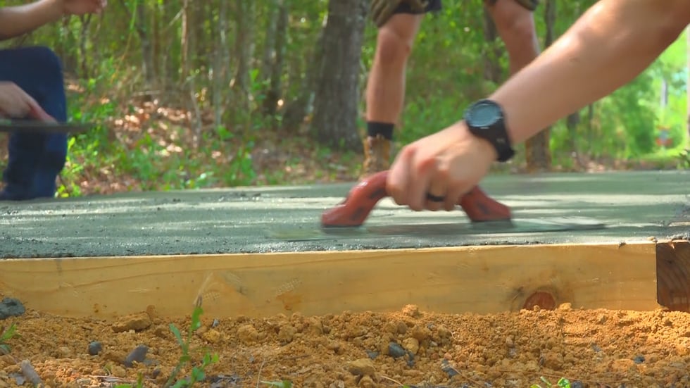 Volunteers from the Navy helped lay concrete for the course’s tee pads.