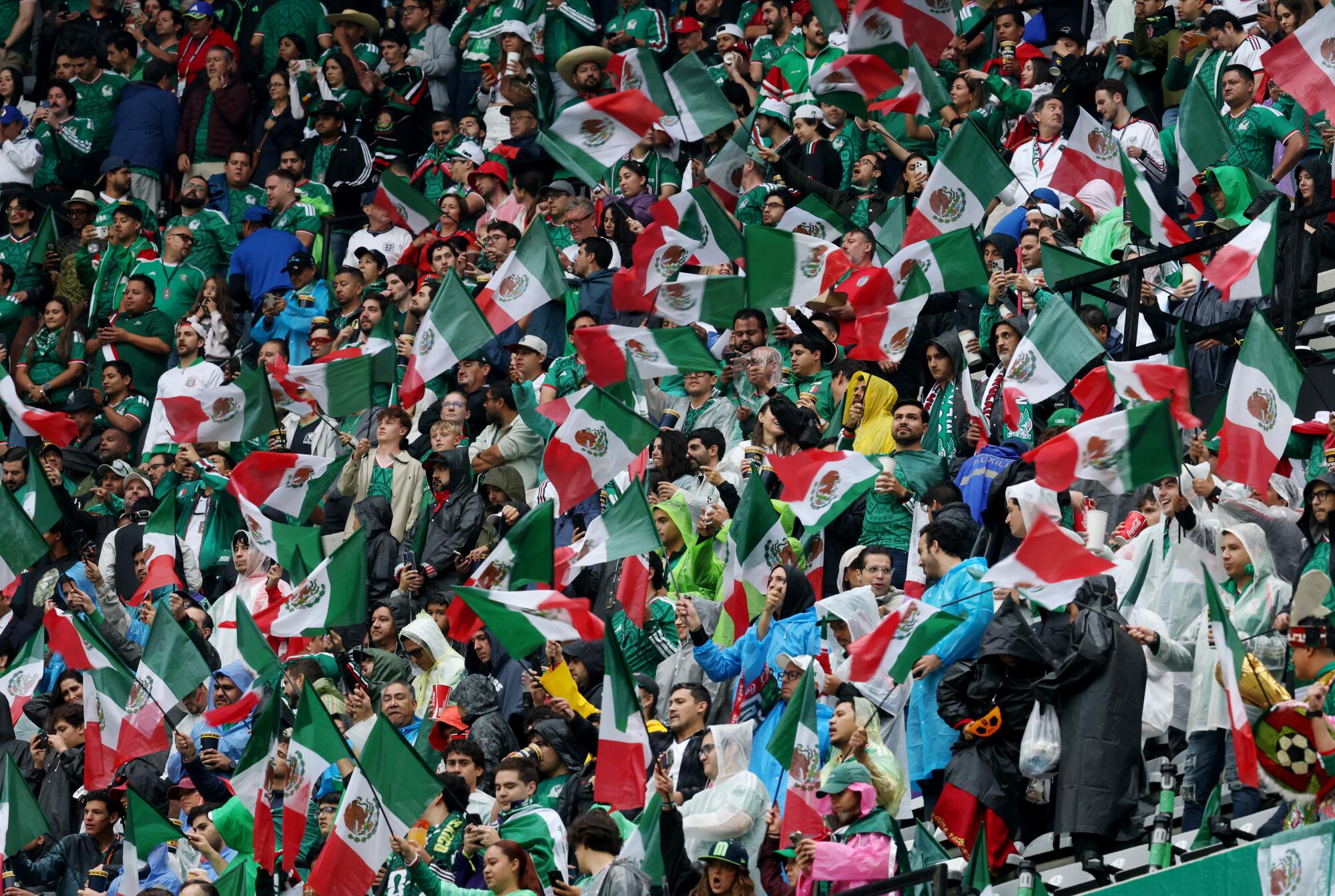 Mexico fans wave flags and show their support before their team faced England in a World Cup match at Azteca Stadium.