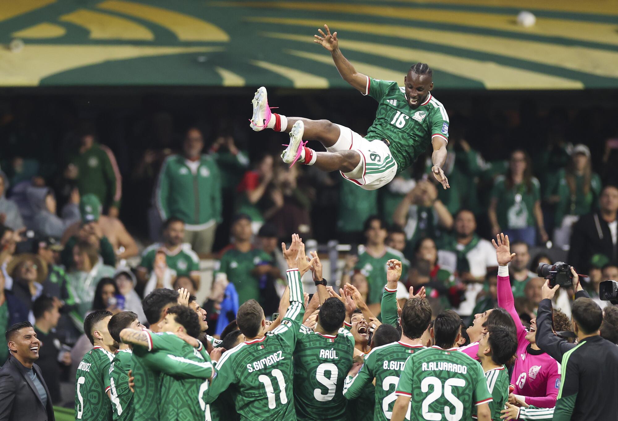Mexico's Julián Quiñones is tossed in the air by teammates as they celebrate a Round of 32 World Cup win over Ecuador.