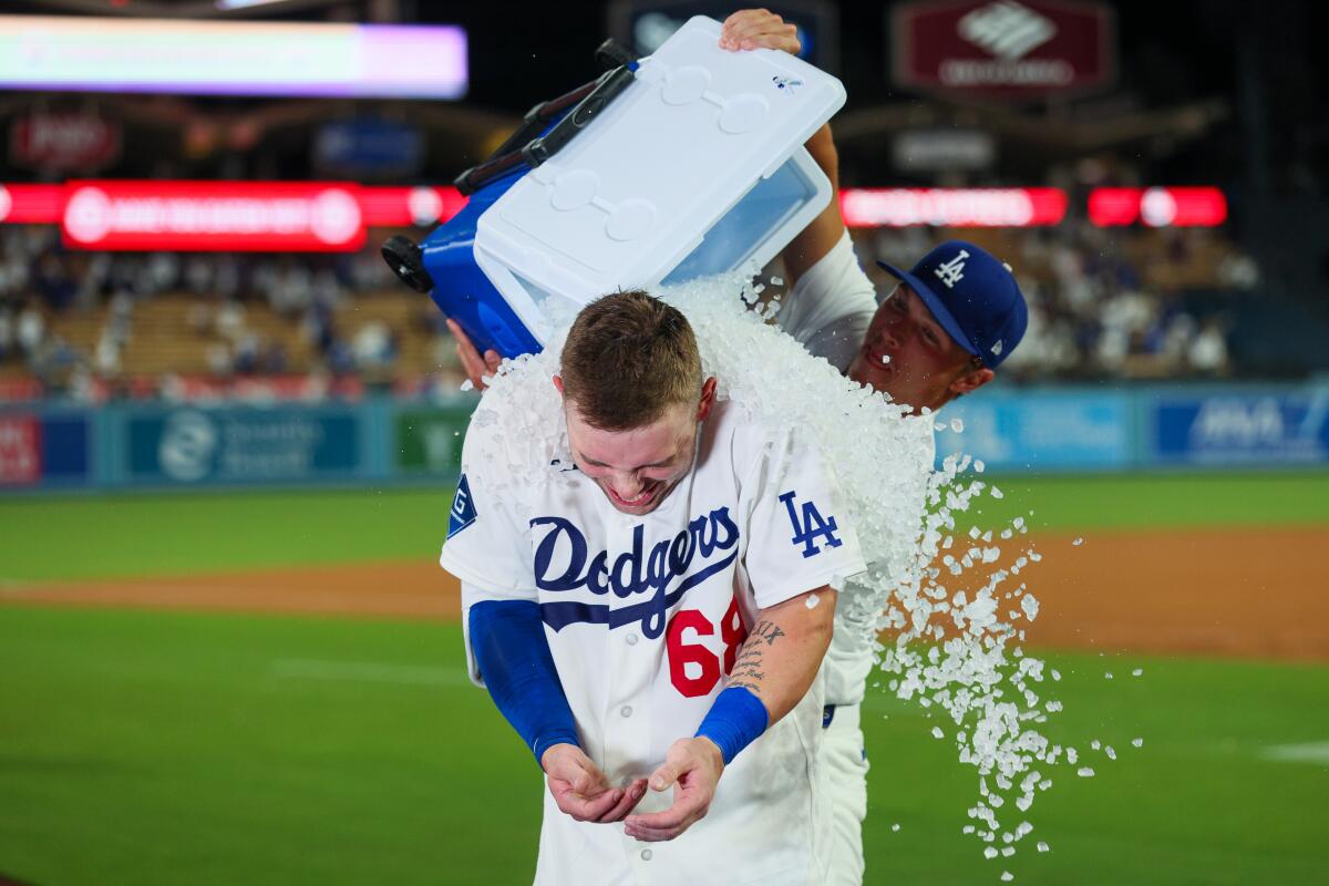 Dalton Rushing is doused in ice by teammate Alex Call after hitting a walk-off single