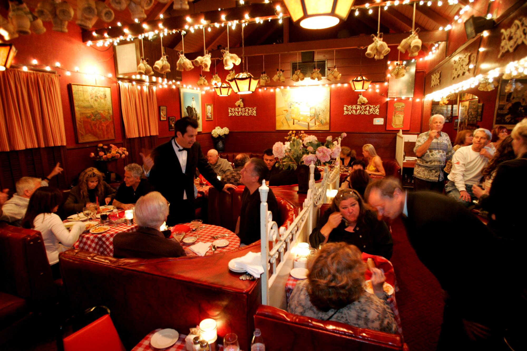 Craig Susser, left in black, has been greeting patrons at Dan Tana's for decades.