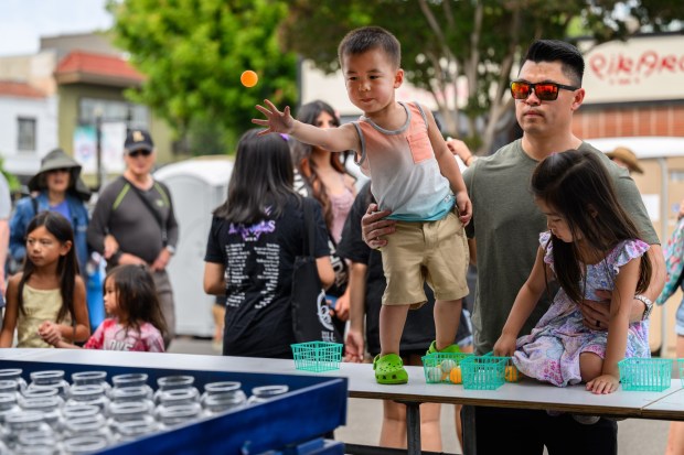 Dylan Lew, 3, of San Ramon, tosses an orange ping-pong ball while playing games at the San Jose Obon Festival in San Jose, Calif., on Saturday, July 11, 2026. (Jose Carlos Fajardo/Bay Area News Group)