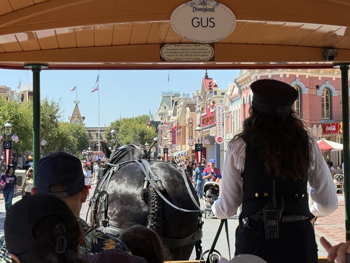 Enjoying a horse-drawn trip around Main Street, U.S.A., is a relaxing start to a Disneyland day.