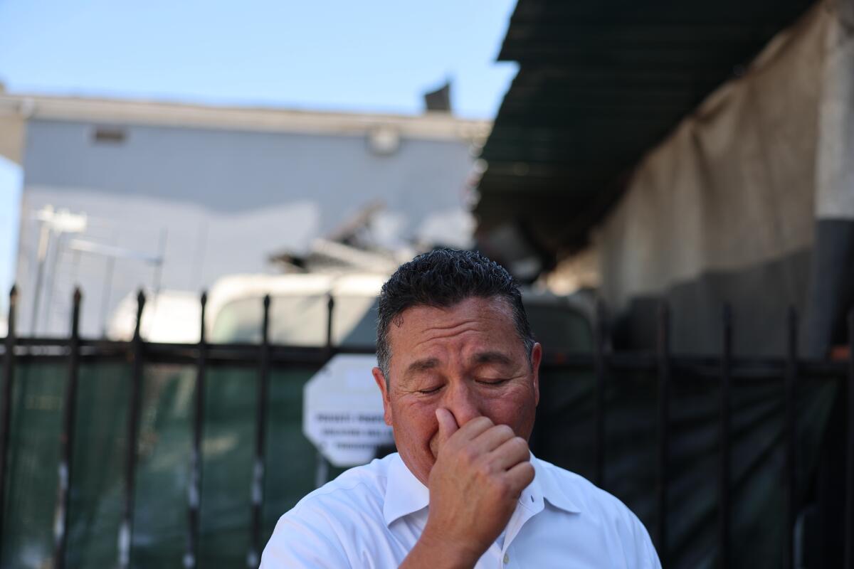 A man holds his nose. 