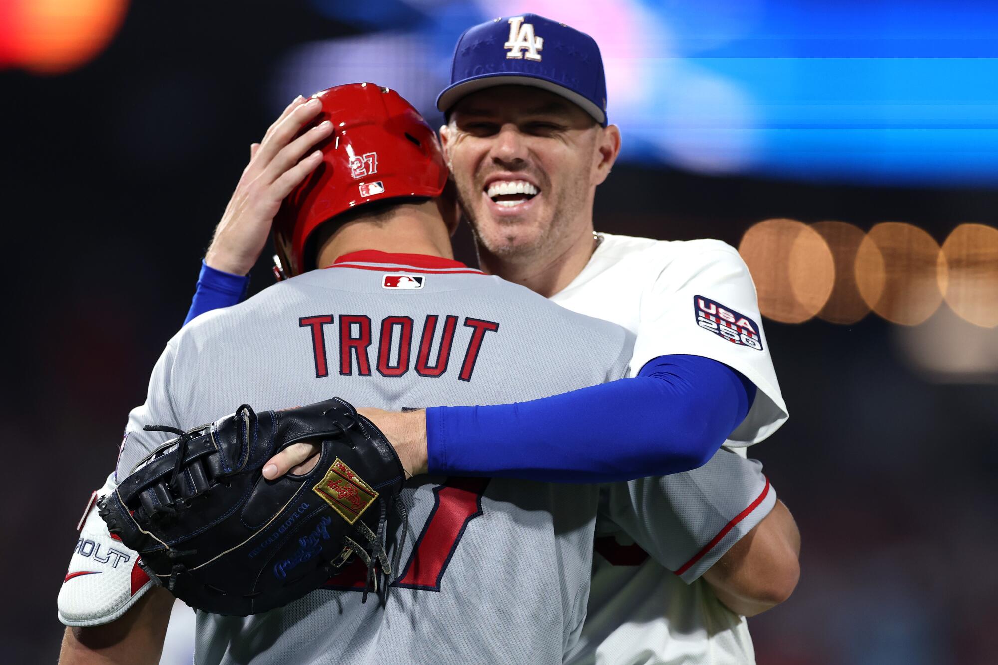 Freddie Freeman and Mike Trout embrace during the fourth inning.