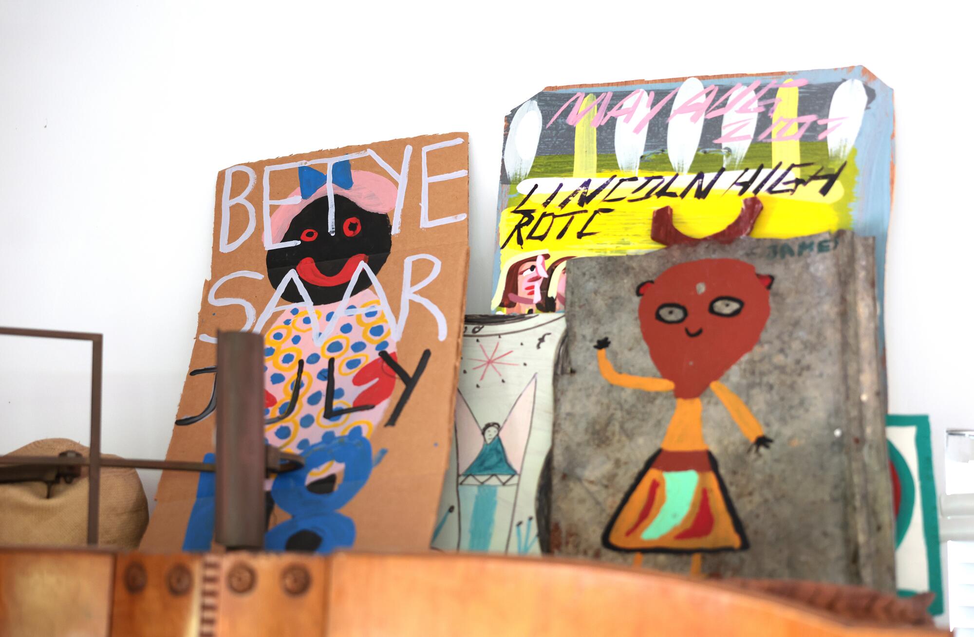 Pieces of art against a white wall.