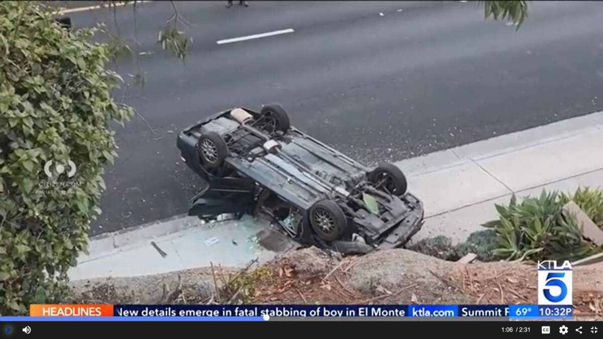A  woman died Saturday after crashing through the fence of an elevated parking lot and landing on Coast Highway below.