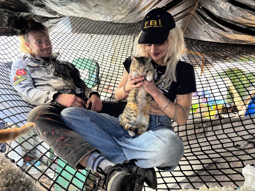 Bradford (left) and Ophelia (right) care for 14 cats in their West Oakland encampment. They are hoping to form their own nonprofit to help mitigate the challenges of finding veterinary care while living on the street for their neighbors.
