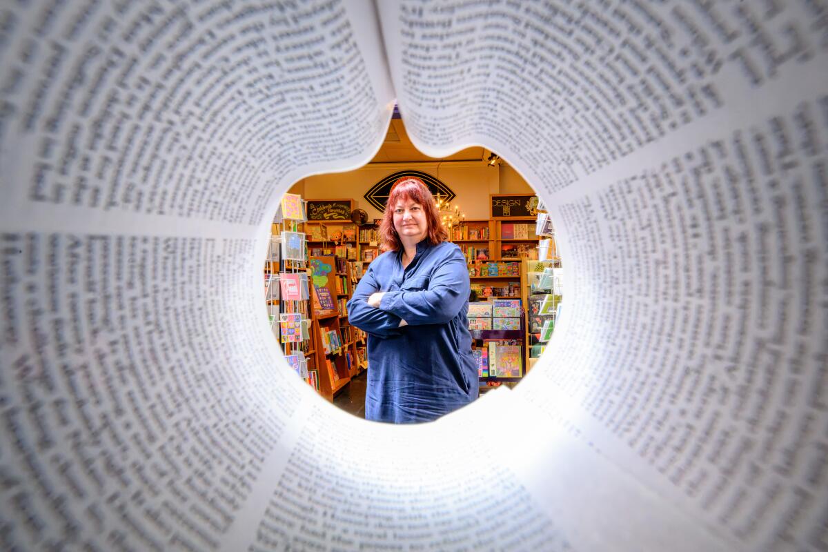 Seen through a magazine, Christin Evans is photographed at her bookstore The Booksmith, in San Francisco