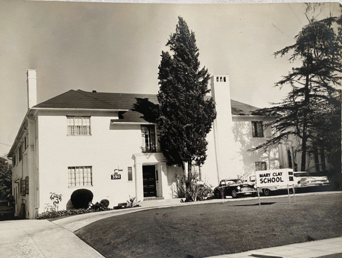 A black and white photo of a two story residence. The sign in front of the building says, "Mary Clay School."