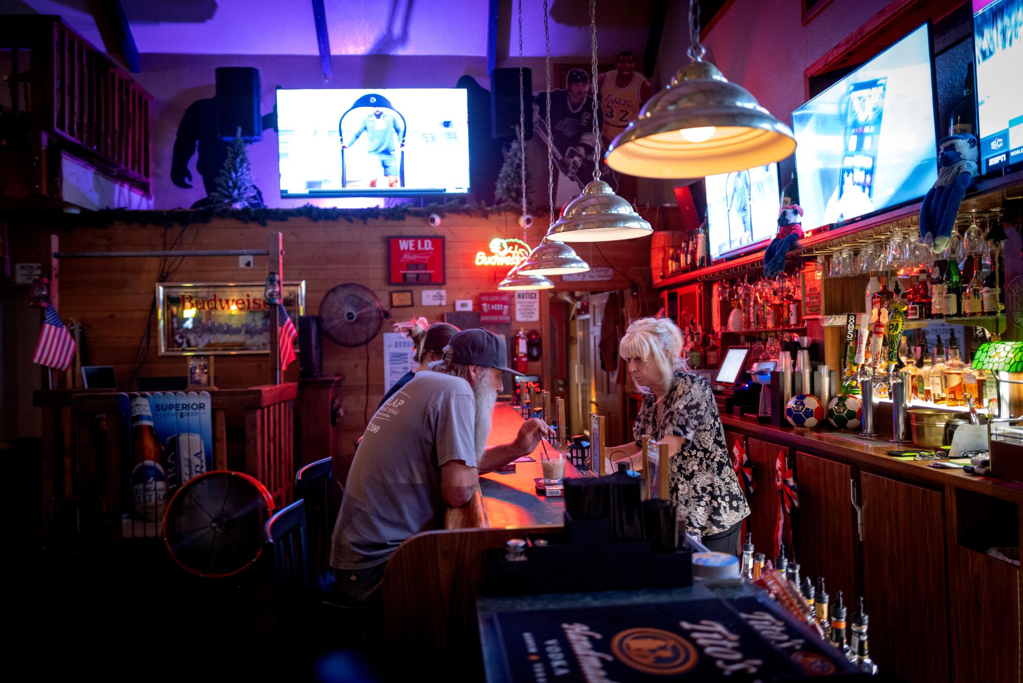 A woman talks to a customer at the Wrightwood Inn.