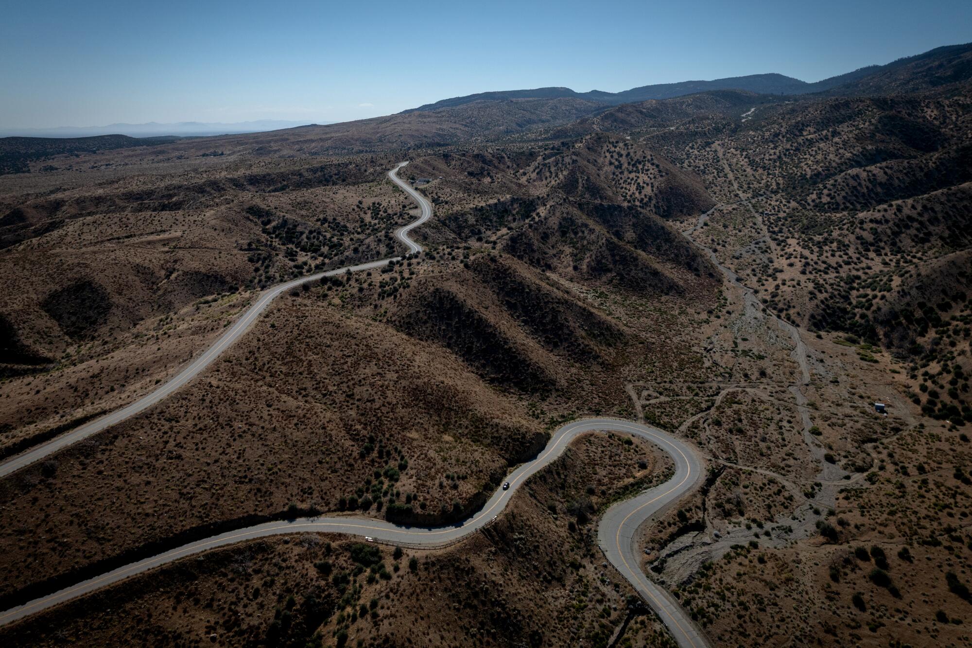 A road passes next to land over the San Andreas fault.